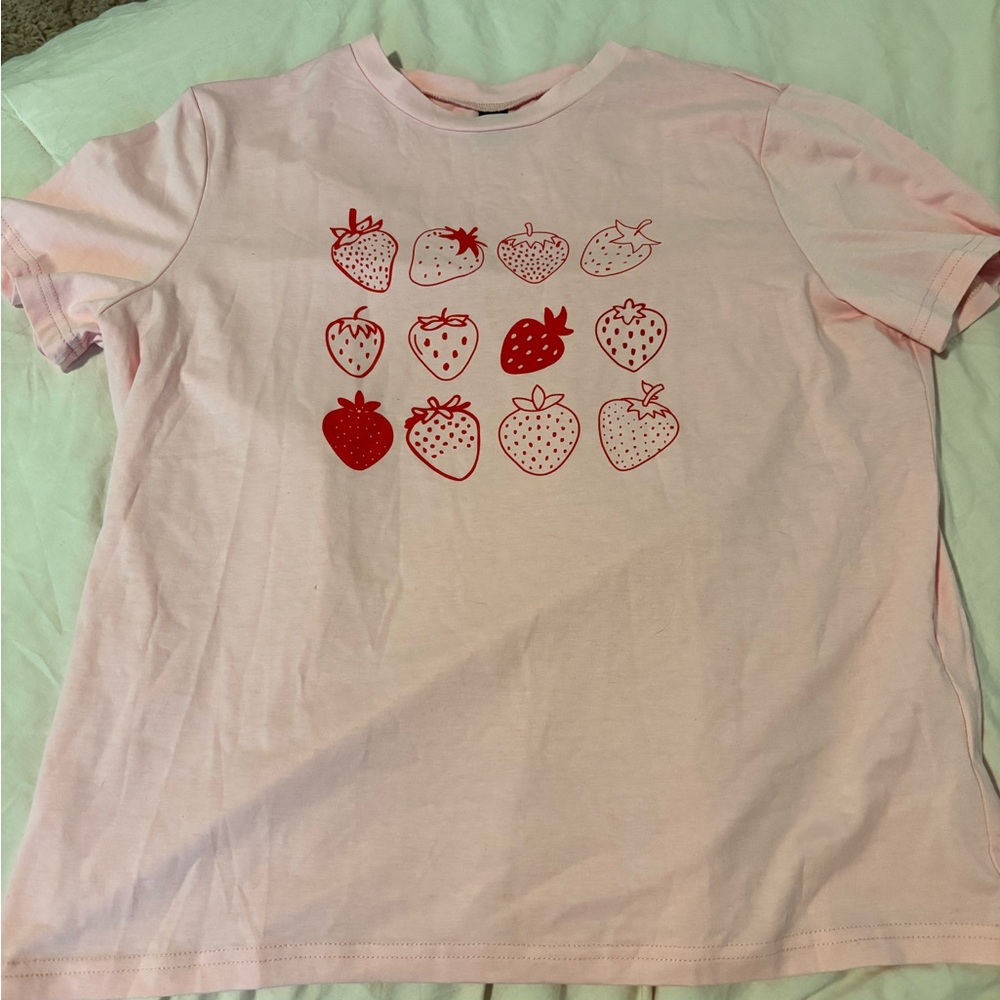 Light pink strawberry shirt.